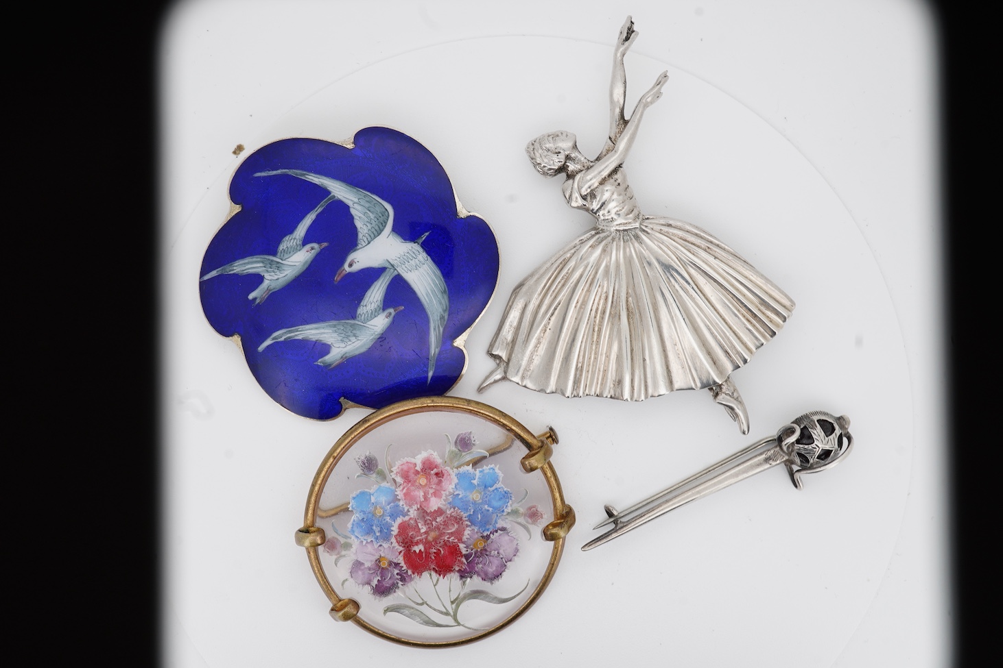 An early to mid 20th century Norwegian 925S and two colour enamelled, brooch, by Ole Nicolai Olberg, depicting three seagulls, 51mm, together with a silver ballerina brooch by D H Phillips Ltd, Birmingham, 1947, a sterli